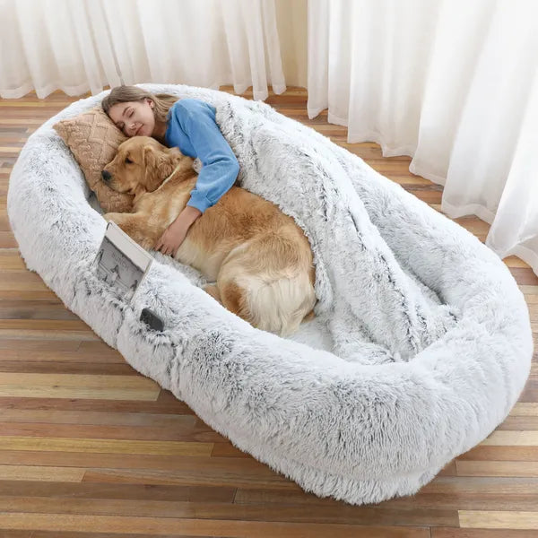 Woman relaxing with her golden retriever on The Companion Lounger in Silver Mist